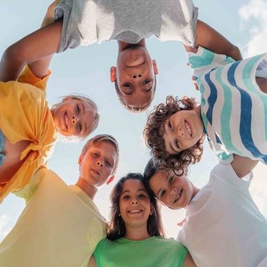bottom view of positive multicultural children looking at camera , kids